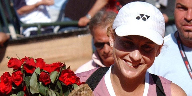 Monica Seles holds a bunch of flowers as she leaves the court at the end of her match against Myriam Casanova of Switzerland