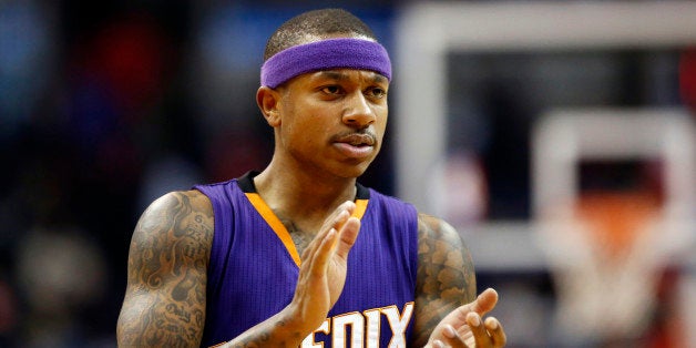 Phoenix Suns guard Isaiah Thomas applauds on the court late in the second half of an NBA basketball game against the Washington Wizards, Sunday, Dec. 21, 2014, in Washington. The Suns won 104-92. (AP Photo/Alex Brandon)