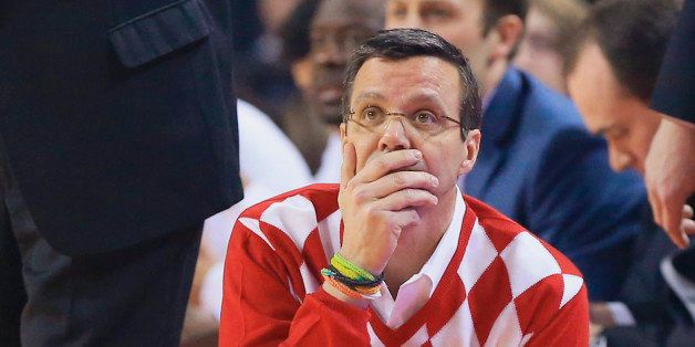Nebraska coach Tim Miles, wearing a throwback sweater, looks at the scoreboard during the first half of an NCAA college basketball game against Iowa in Lincoln, Neb., Sunday, Feb. 22, 2015. (AP Photo/Nati Harnik)