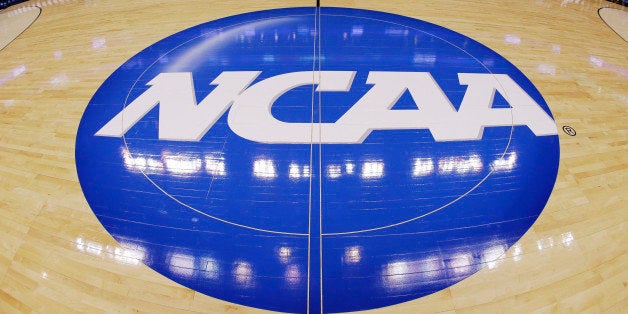 FILE - In this March 21, 2013, file photo, in this image taken with a fisheye lens, the NCAA logo is displayed at mid-court b