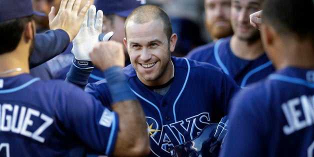 Tampa Bay Rays' Evan Longoria high-fives teammates in the dugout after hitting a solo home run in the first inning of a baseball game against the Baltimore Orioles, Thursday, Aug. 28, 2014, in Baltimore. (AP Photo/Patrick Semansky)