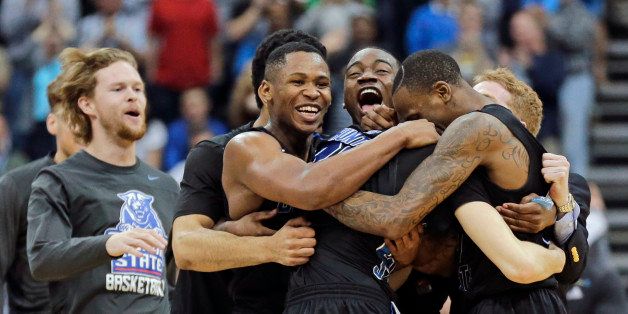 Georgia State players celebrate as they surround R.J. Hunter, center, after he made the game winning shot against Baylor an NCAA tournament second round college basketball game, Thursday, March 19, 2015, in Jacksonville, Fla. Georgia State won 57-56. (AP Photo/Chris O'Meara)