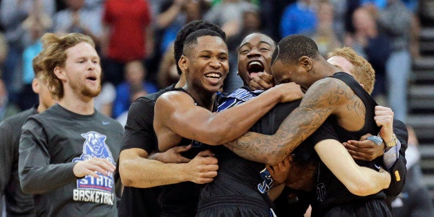 Georgia State players celebrate as they surround R.J. Hunter, center, after he made the game winning shot against Baylor an N