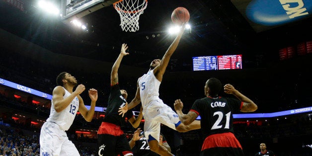 Kentucky's Andrew Harrison (5) drives in for the basket and a foul as the Wildcats defeated Cincinnati, 64-51, in the third round of the NCAA Tournament on Saturday, March 21, 2015, at the KFC Yum! Center in Louisville, Ky. (Mark Cornelison/Lexington Herald-Leader/TNS via Getty Images)