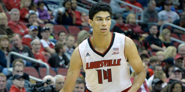 Louisville freshman Anas Mahmoud llooks over the defense during the second half of an NCAA college basketball scrimmage Sunda