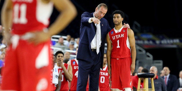 HOUSTON, TX - MARCH 27: Head coach Larry Krystkowiak speaks with Isaiah Wright #1 of the Utah Utes against the Duke Blue Devils during a South Regional Semifinal game of the 2015 NCAA Men's Basketball Tournament at NRG Stadium on March 27, 2015 in Houston, Texas. (Photo by Ronald Martinez/Getty Images)