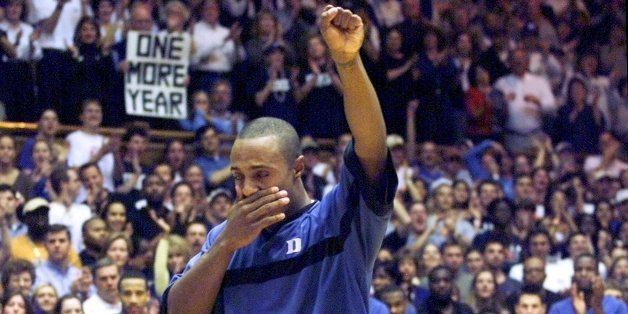 Duke's Jason WIlliams, center, is overcome with emotion as he is introduced before his final home game against North Carolina Sunday, March 3, 2002, at Cameron Indoor Stadium in Durham, N.C. Williams, a junior who is on track to graduate in three years, has announced that he will forego his senior season to enter the NBA draft.(AP Photo/Grant Halverson)
