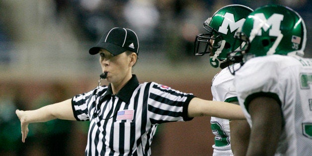 Line judge Sarah Thomas blows her whistle to stop the clock during the second half Little Caesars Pizza Bowl NCAA college football game between Marshall and Ohio Saturday, Dec. 26, 2009, in Detroit. Thomas is one of five women officiating in major college football, but Pizza Bowl spokesman Tim Moore said she was the first to draw an assignment for a Bowl Subdivision postseason game. (AP Photo/Duane Burleson)