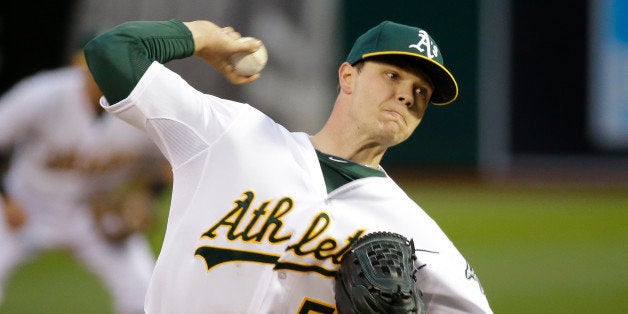 Oakland Athletics starting pitcher Sonny Gray throws against the Texas Rangers in the first inning of their opening day baseball game Monday, April 6, 2015, in Oakland, Calif. (AP Photo/Eric Risberg)