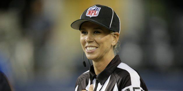 FILE - In this Aug. 15, 2014, file photo, developmental line judge Sarah Thomas smiles in the second half of a preseason NFL football game between the Seattle Seahawks and the San Diego Chargers in Seattle. The NFL has its first full-time female game official. Sarah Thomas, who has worked exhibition games, will be a line judge for the 2015 season, the league announced Wednesday, April 8, 2015. (AP Photo/Stephen Brashear, File)