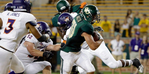 Northwestern State inebacker Adam Jones (3) gives chase as Baylor's Silas Nacita (31) fights his way into the end zone for a score late in the second half of an NCAA college football game, Saturday, Sept. 6, 2014, in Waco, Texas. Baylor won 70-6. (AP Photo/Tony Gutierrez)