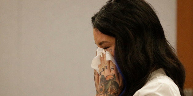 Christine Mackinday, also known as Christy Mack, cries on the witness stand during a preliminary hearing for Jonathan Paul Koppenhaver, also known as War Machine, Friday, Nov. 14, 2014, in Las Vegas. Koppenhaver is accused of assaulting his former girlfriend Mackinday. (AP Photo/John Locher)