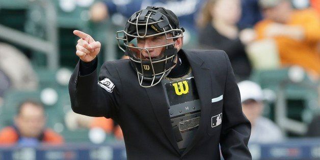 Home plate umpire Lance Barksdale signals during the fourth inning of a baseball game between the Detroit Tigers and the Minnesota Twins, Thursday, April 9, 2015, in Detroit. (AP Photo/Carlos Osorio)