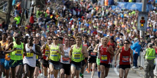 Runners run along the route of the 118th Boston Marathon Monday, April 21, 2014, in Hopkinton, Mass. (AP Photo/Steven Senne)
