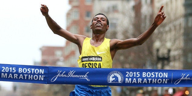 BOSTON, MA - APRIL 20: Lelisa Desisa of Ethiopa crosses the finish line to win the 119th Boston Marathon on April 20, 2015 i