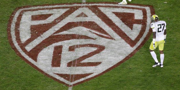 Oregon defensive back Terrance Mitchell (27) walks next to a Pac-12 logo on the field at Stanford Stadium during an NCAA college football game against Stanford in Stanford, Calif., Thursday, Nov. 7, 2013. (AP Photo/Jeff Chiu)