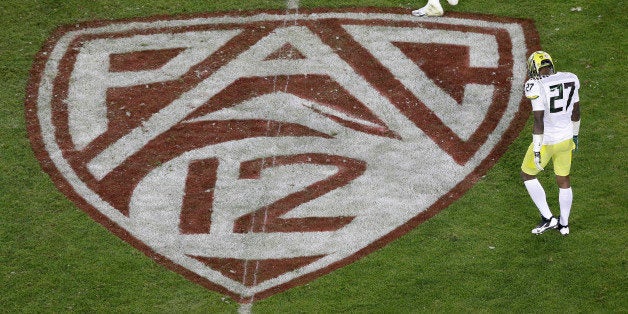 Oregon defensive back Terrance Mitchell (27) walks next to a Pac-12 logo on the field at Stanford Stadium during an NCAA coll