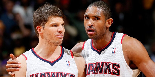 ATLANTA, GA - MARCH 13: Al Horford #15 of the Atlanta Hawks converses with Kyle Korver #26 prior to his second set of free t