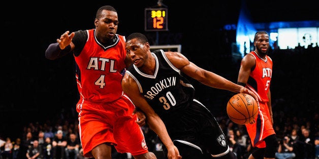 NEW YORK, NY - APRIL 25: Thaddeus Young #30 of the Brooklyn Nets drives past Paul Millsap #4 of the Atlanta Hawks during the