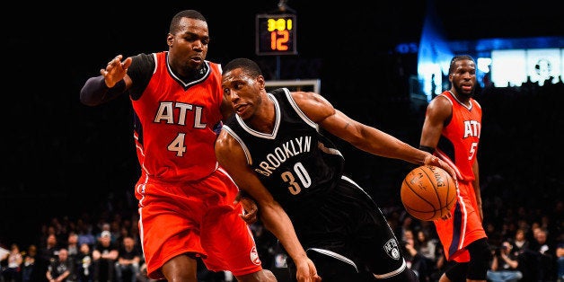 NEW YORK, NY - APRIL 25: Thaddeus Young #30 of the Brooklyn Nets drives past Paul Millsap #4 of the Atlanta Hawks during the first round of the 2015 NBA Playoffs at Barclays Center on April 25, 2015 in the Brooklyn borough of New York City. NOTE TO USER: User expressly acknowledges and agrees that, by downloading and/or using this photograph, user is consenting to the terms and conditions of the Getty Images License Agreement. (Photo by Alex Goodlett/Getty Images)