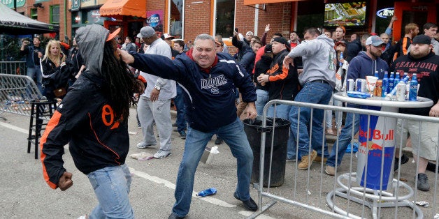 A protestor, left, fights with a bar patron outside of a bar near Oriole Park at Camden Yards after a rally for Freddie Gray, Saturday, April 25, 2015, in Baltimore. Gray died from spinal injuries about a week after he was arrested and transported in a police van. (AP Photo/Patrick Semansky)