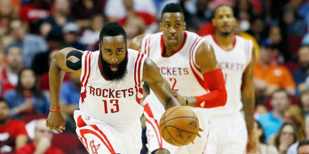 HOUSTON, TX - APRIL 15: James Harden #13 of the Houston Rockets takes the baskeball upcourt as Dwight Howard #12 and Trevor