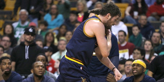 BOSTON, MA - APRIL 26: Kevin Love #0 of the Cleveland Cavaliers runs by teammates off of the court after an injury against th