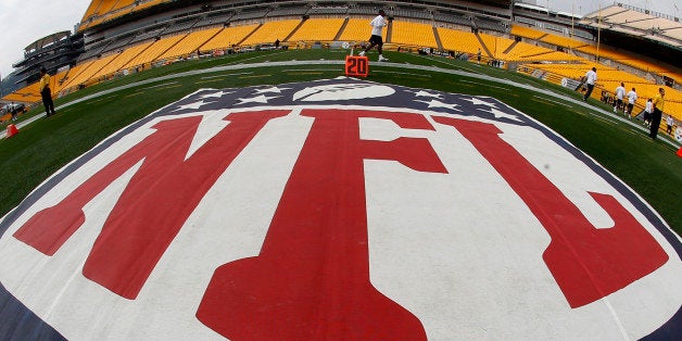 In this image made with a fisheye lens, the NFL logo is displayed on the sideline of Heinz Field as the Tennessee Titans warm up before an NFL football game against the Pittsburgh Steelers, Sunday, Sept. 8, 2013 in Pittsburgh. (AP Photo/Keith Srakocic)