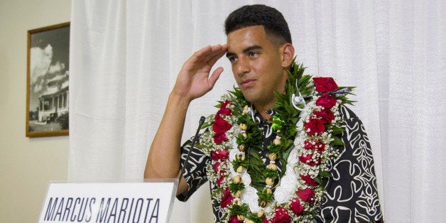 Former Oregon quarterback Marcus Mariota gestures while meeting with the media after being selected in the first round with the second pick by the Tennessee Titans on NFL Draft Day Thursday, April 30, 2015, in Honolulu. Mariota along with his family and friends gathered at the Saint Louis Alumni Clubhouse to celebrate his selection in the NFL Draft. (AP Photo/Eugene Tanner)