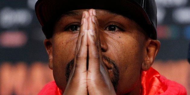 Boxer Floyd Mayweather Jr. listens during a press conference Wednesday, April 29, 2015, in Las Vegas. Mayweather will face Manny Pacquiao in a welterweight title fight in Las Vegas on Saturday. (AP Photo/John Locher)