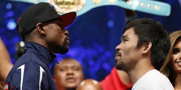 Floyd Mayweather Jr., left, and Manny Pacquiao pose during their weigh-in on Friday, May 1, 2015 in Las Vegas. The world welt