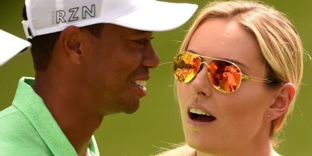 Tiger Woods (L) speaks with US Skier Lindsey Vonn during the Par 3 competition on April 8, 2015, at Augusta National Golf Clu