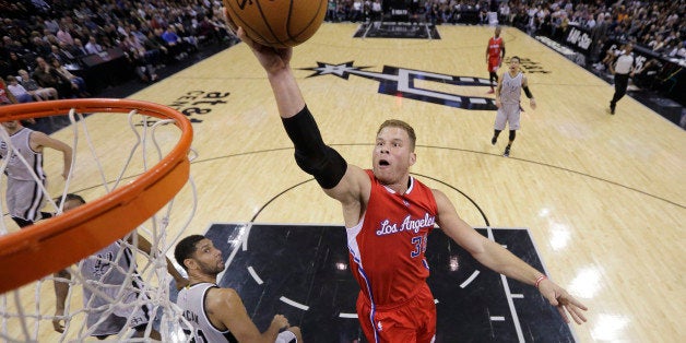 Los Angeles Clippersâ Blake Griffin scores over San Antonio Spursâ Tim Duncan (21) during the first half of an NBA basket