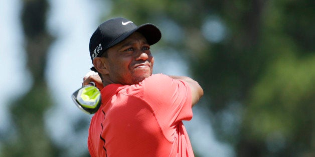 Tiger Woods hits from the 16 tee during the final round of The Players Championship golf tournament Sunday, May 10, 2015, in