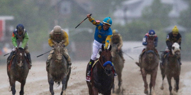 American Pharoah, ridden by Victor Espinoza, center, wins the 140th Preakness Stakes horse race at Pimlico Race Course, Saturday, May 16, 2015, in Baltimore. (AP Photo/Patrick Semansky)