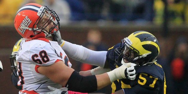 Michigan defensive end Frank Clark (57) goes up against Illinois offensive linesman Simon Cvijanovic (68) during the second half of an NCAA college football game at Michigan Stadium in Ann Arbor, Mich., Saturday, Oct. 13, 2012. (AP Photo/Carlos Osorio)