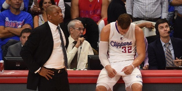 Coach Doc Rivers (L) and forward Blake Griffin of the Los Angeles Clippers (R) are pictured during game six against the Houston Rockets in the second round of the Western Conference playoffs at the Staples Center in Los Angeles, California, on May 13, 2015. The Rockets won 119-107. AFP PHOTO / MARK RALSTON (Photo credit should read MARK RALSTON/AFP/Getty Images)