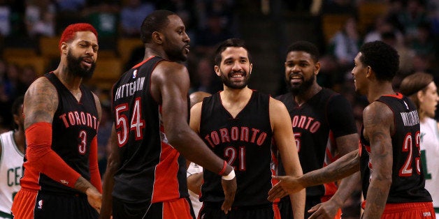 BOSTON, MA - APRIL 14: Greivis Vasquez #21 of the Toronto Raptors reacts with teammates James Johnson #3, Patrick Patterson #54, Amir Johnson #15 and Louis Williams #23 after a play at the start of the fourth quarter against the Boston Celtics at TD Garden on April 14, 2015 in Boston, Massachusetts. NOTE TO USER: User expressly acknowledges and agrees that, by downloading and/or using this photograph, user is consenting to the terms and conditions of the Getty Images License Agreement. (Photo by Mike Lawrie/Getty Images)