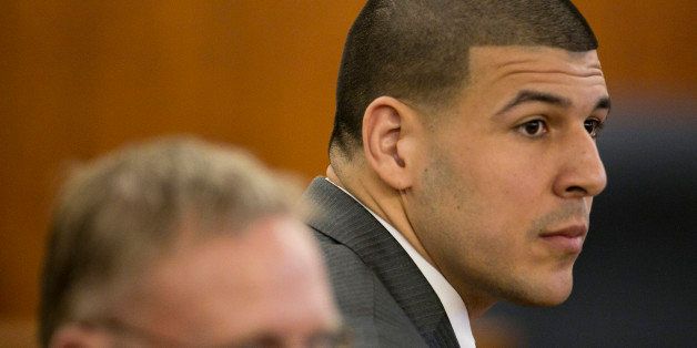 Former New England Patriots NFL football player Aaron Hernandez listens during his murder trial at the Bristol County Superior Court in Fall River, Mass., on Wednesday, April 15, 2015. Hernandez is accused of killing Odin Lloyd in June 2013. (Dominick Reuter/Pool Photo via AP)