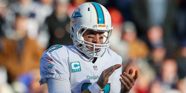 FOXBORO, MA - DECEMBER 14: Ryan Tannehill #17 of the Miami Dolphins reacts during the second quarter against the New England Patriots at Gillette Stadium on December 14, 2014 in Foxboro, Massachusetts. (Photo by Jim Rogash/Getty Images)