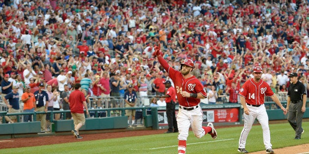 Washington Nationals' Bryce Harper gestures as he heads home after he hit a two-run walk-off home run during the ninth inning