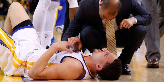 OAKLAND, CA - MAY 27: Klay Thompson #11 of the Golden State Warriors is injured in the fourth quarter against the Houston Rockets during game five of the Western Conference Finals of the 2015 NBA Playoffs at ORACLE Arena on May 27, 2015 in Oakland, California. NOTE TO USER: User expressly acknowledges and agrees that, by downloading and or using this photograph, user is consenting to the terms and conditions of Getty Images License Agreement. (Photo by Ezra Shaw/Getty Images)