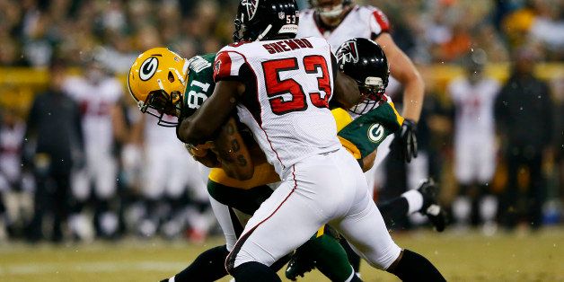 GREEN BAY, WI - DECEMBER 08: Andrew Quarless #81 of the Green Bay Packers is tackled by Prince Shembo #53 and Paul Worrilow #55 of the Atlanta Falcons in the first half at Lambeau Field on December 8, 2014 in Green Bay, Wisconsin. (Photo by Kevin C. Cox/Getty Images)