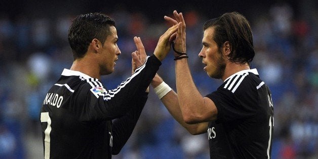 Real Madrid's Portuguese forward Cristiano Ronaldo (L) and Real Madrid's Welsh forward Gareth Bale (R) celebrate a goal during the Spanish league football match RCD Espanyol vs Real Madrid CF atÂ the Cornella-El Prat stadium in Cornella de Llobregat on May 17, 2015. AFP PHOTO / LLUIS GENE (Photo credit should read LLUIS GENE/AFP/Getty Images)