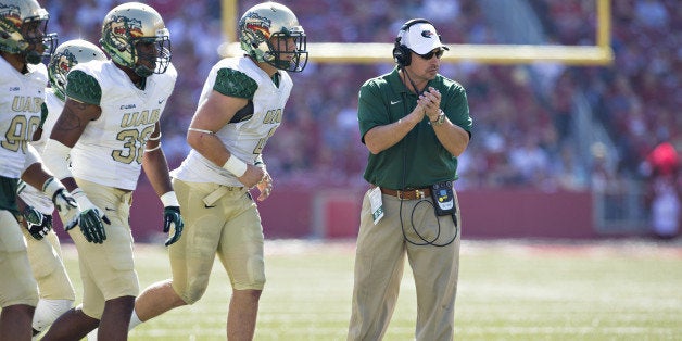 FAYETTEVILLE, AR - OCTOBER 25: Head Coach Bill Clark of the UAB Blazers claps for his team as the run onto the field during a game against the Arkansas Razorbacks at Razorback Stadium on October 25, 2014 in Fayetteville, Arkansas. The Razorbacks defeated the Blazers 45-17. (Photo by Wesley Hitt/Getty Images)