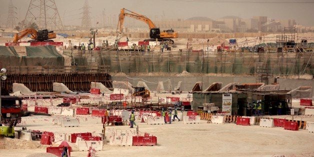 In this photo taken during a government organized media tour, laborers work at the Al-Wakra Stadium that is under construction for the 2022 World Cup, in Doha, Qatar, Monday, May 4, 2015. Qatarâs top labor official told The Associated Press Monday that Qatarâs inability to ensure decent housing for its bulging migrant labor population was âa mistakeâ the government is working to fix as it prepares to host the 2022 World Cup, vowing his country would improve conditions for its vast foreign labor force. (AP Photo/Maya Alleruzzo)