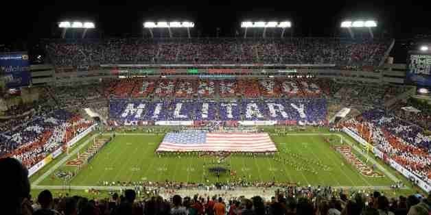 IN THIS IMAGE DISTRIBUTED BY AP IMAGES FOR USAA - An overall inside view of Raymond James Stadium as fans honor military and veterans before an NFL game between the Miami Dolphins and the Tampa Bay Buccaneers, Monday, November 11, 2013 in Tampa, Fla. 50,000 cards were provided to fans by USAA, the official military appreciation sponsor of the NFL. (David Drapkin/AP images for USAA)