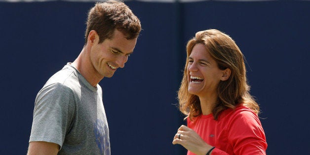 Andy Murray of Britain shares a laugh with his new coach Amelie Mauresmo during a training session before his Queen's Club grass court championships tennis match in London, Thursday, June 12, 2014. (AP Photo/Sang Tan)