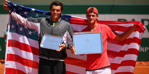 PARIS, FRANCE - JUNE 06: (L-R) Runner up Taylor Harry Fritz of United States and winner Tommy Paul of the United States pose with their trophy after the Boy's Singles Final on day fourteen of the 2015 French Open at Roland Garros on June 6, 2015 in Paris, France. (Photo by Dan Istitene/Getty Images)