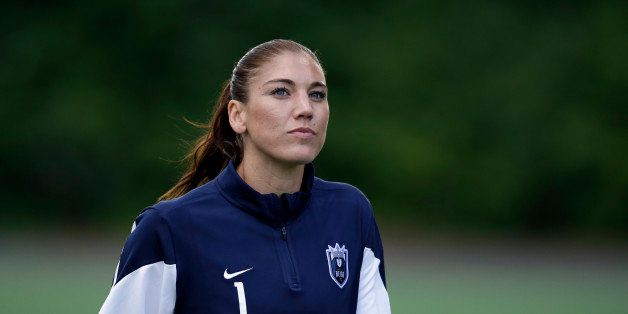 Seattle Reign FC goalie Hope Solo leaves the field after the first half of an NWSL soccer game against the Sky Blue FC Saturday, June 28, 2014, in Seattle. Solo was arrested at a suburban Seattle home on suspicion of assaulting her sister and 17-year-old nephew a week ago, then pleaded not guilty and was released without bail after a court appearance Monday, June 23. She was eligible to play in Saturday's match, but did not start. (AP Photo/Elaine Thompson)